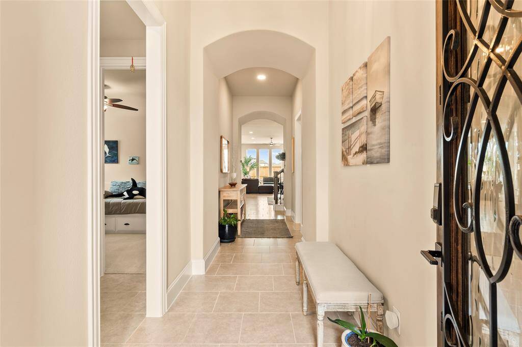 Wi-Fi smart door locks and deadbolts are also key-operated too.  Upgraded 11-foot high ceilings throughout; 8-foot high interior doors throughout. Welcoming hallway entrance with arched doorways, elegant tile flooring and soft, neutral paint tones.
