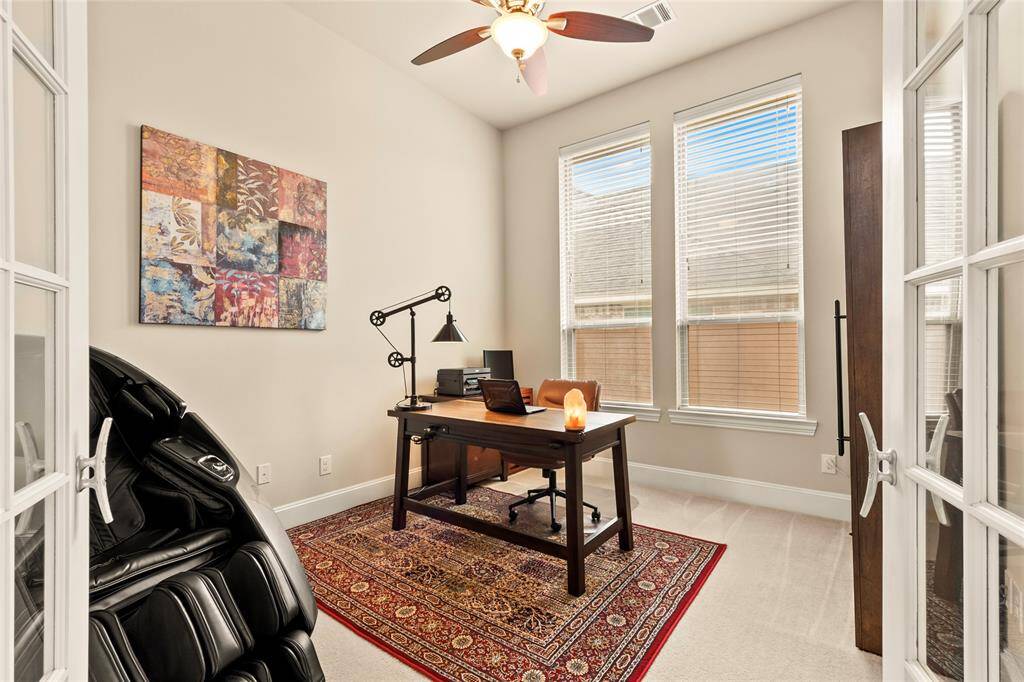 Modern home-office with French doors, neutral paint tones, large windows and ceiling fan.  Cat-5 data drops in all rooms, hub in mud room with a pass-through to garage