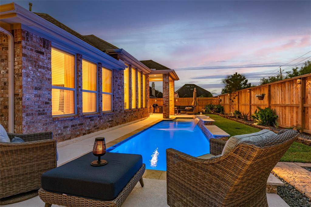 In-ground swimming pool with durable Spray Deck surrounding, stone coping and water features; recent Maytronics Dolphin installed. All pool equipment, robot, brushes and nets convey.