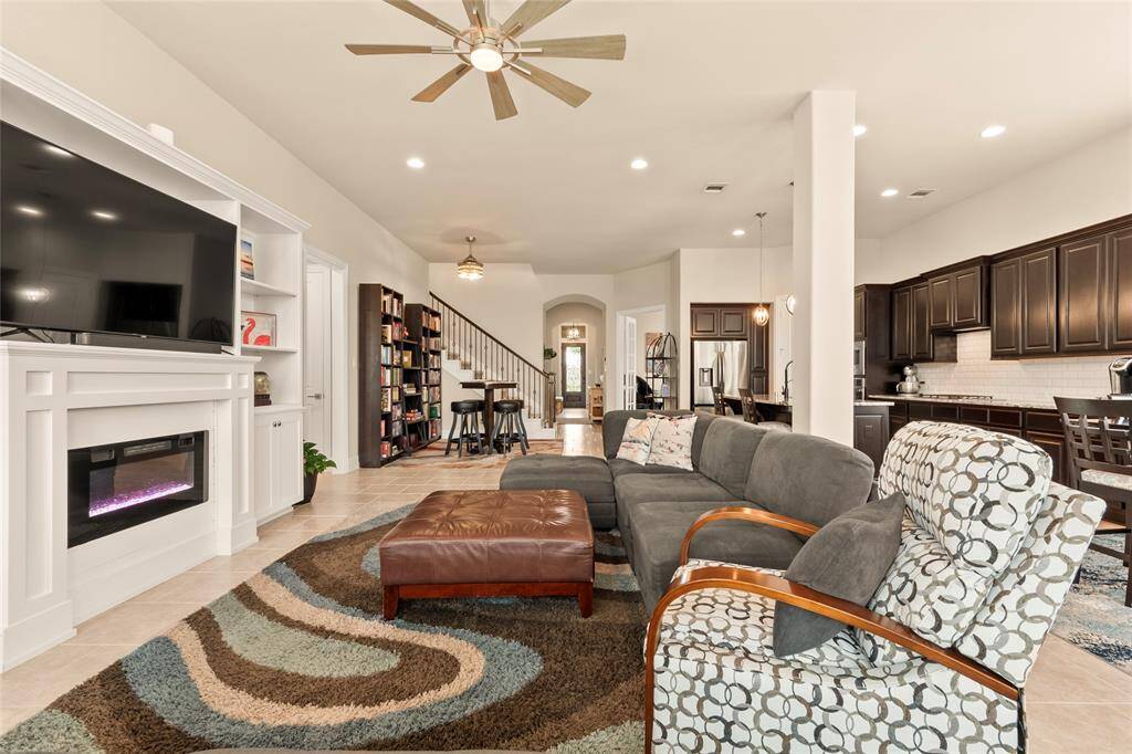 Upgraded 5” base boards and 8-foot high interior doors throughout. Open concept view of the living and formal dining area. Natural light enhances the welcoming ambiance, and a staircase leads to the upper level.
