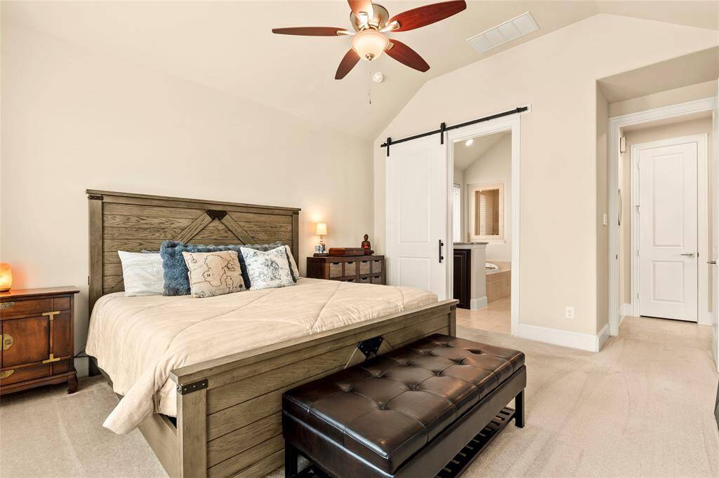 This cozy Primary bedroom features a sliding barn door that leads to the Primary bathroom, enhancing convenience and privacy.