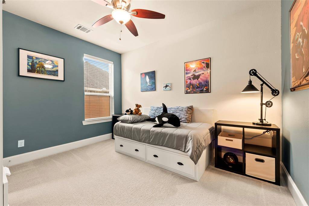 This spacious bedroom features a high ceiling, sizable closet  and large window for natural light.