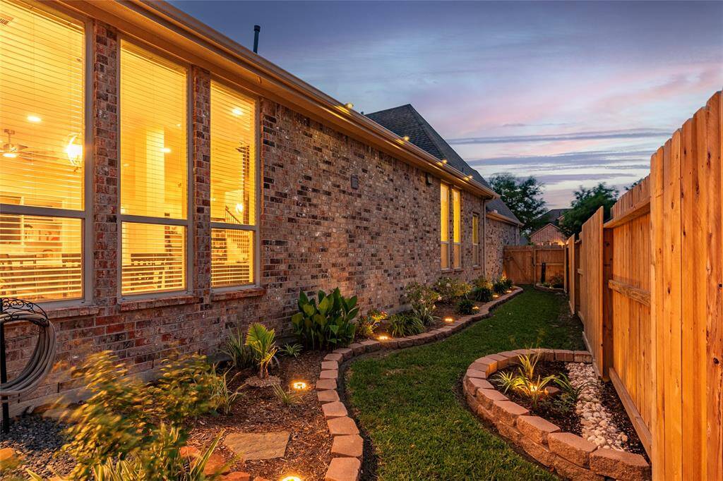 Envious Curb Appeal!  The beautiful professionally landscaped yard features full gutters piped directly in-ground with hard PVC drains and drain grates. 4 exterior security cameras with base station, monitor, wireless router/antenna and remotes convey.