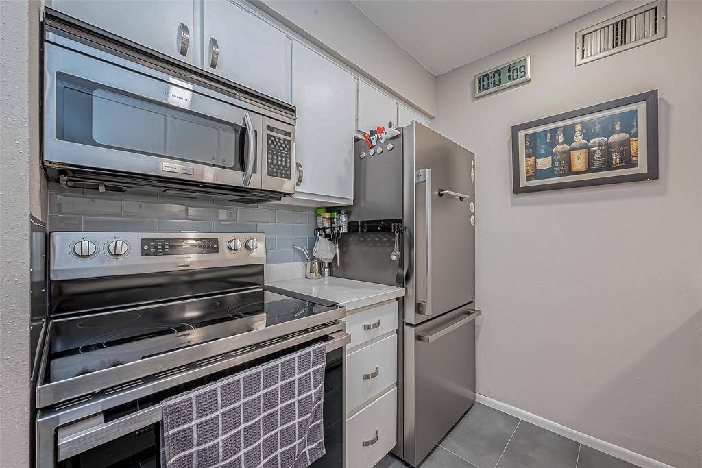 Stainless appliances and recent over and under fridge that stays with the property.