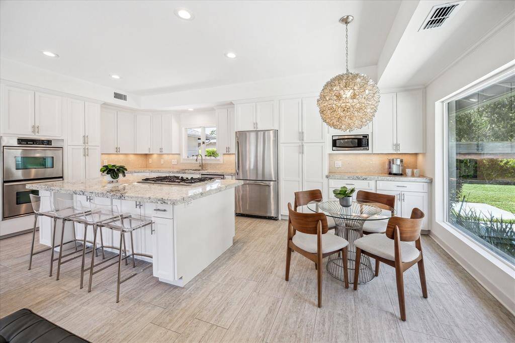 A bright breakfast area off the kitchen allows for dining with a view of your outdoor living area.