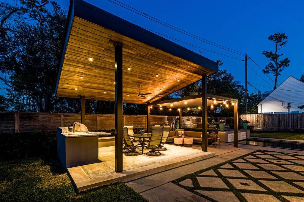 The outdoor kitchen is lit for outdoor entertaining.