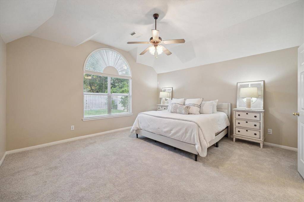 The Primary Suite features a coved ceiling, a large arched window overlooking the backyard.  This expansive room will accommodate large scale furniture.  New carpet in all bedrooms (April 2025).