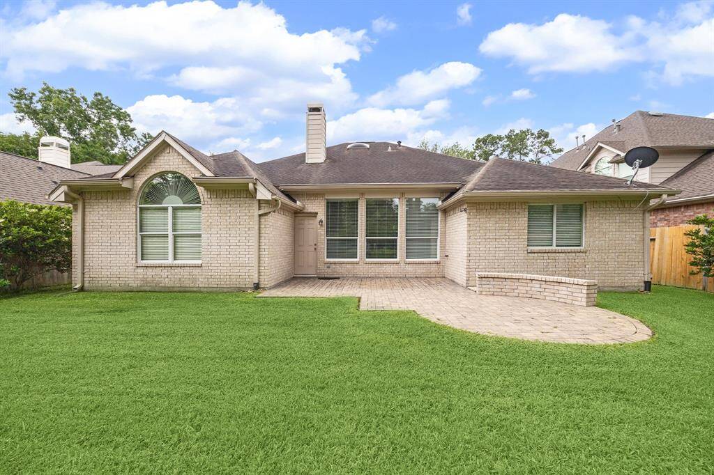 Brick and cement board on all four sides.  Custom paverstone patio with arched bench seat.  Serene backyard.