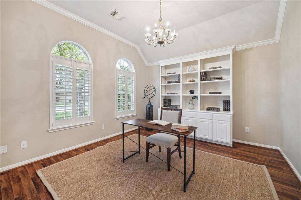 The Home Office has a great view of the front yard through the arched windows. Not pictured are wide double French doors that can make this room private for work meetings.