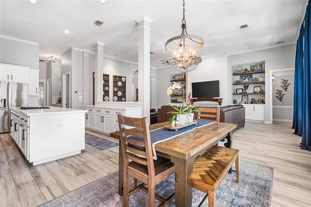 OPEN CONCEPT LIVING AT ITS FINEST.  CUSTOM WOOD SHELVING CAN BE FOUND IN THE LIVING ROOM SURROUNDING THE FIREPLACE.