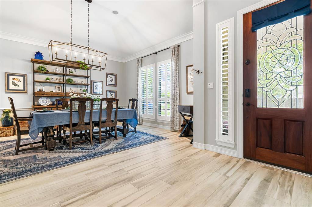 STEP INSIDE AND BE WELCOMED BY BEAUTIFUL WOOD-LOOK TILE FLOORING AND UPGRADED LIGHT FIXTURES THROUGHOUT THE HOME.