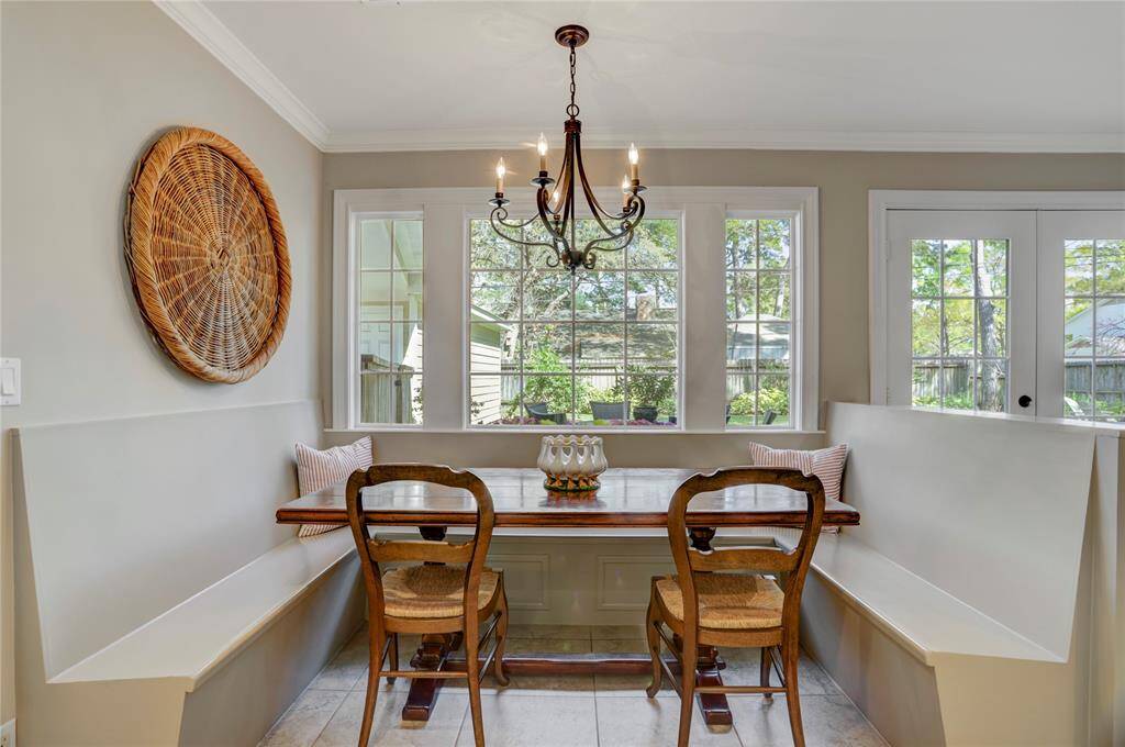 The breakfast room is another example of thoughtful design with its stylish wrought iron chandelier and custom banquette seating for up to 8.