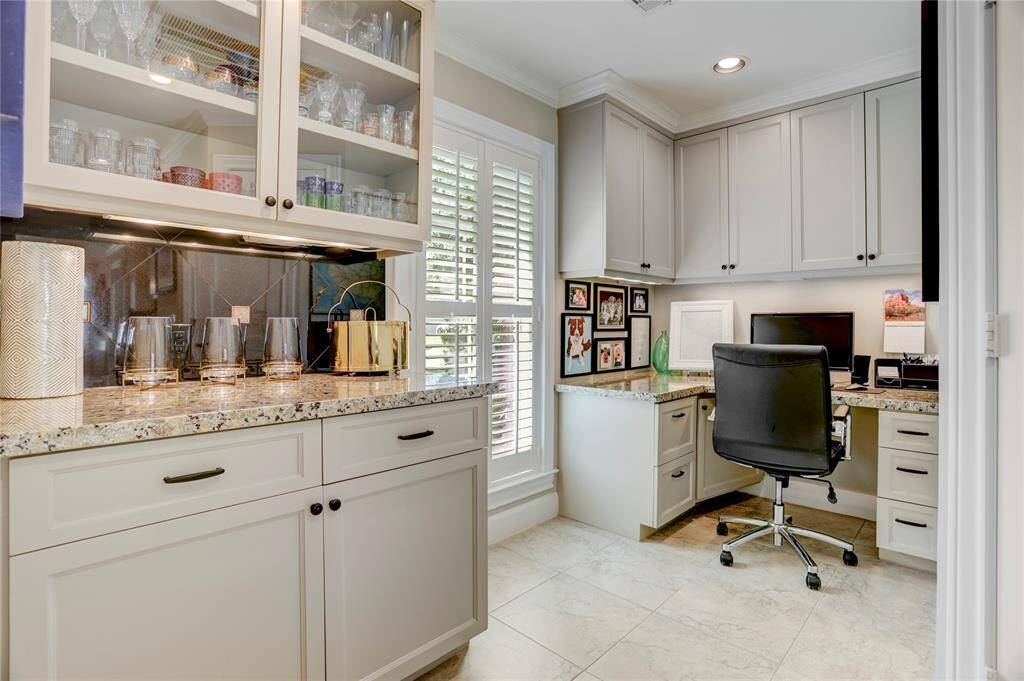 The butler's pantry, chef's office and walk-in pantry are conveniently nestled together between the formal dining room and the kitchen.