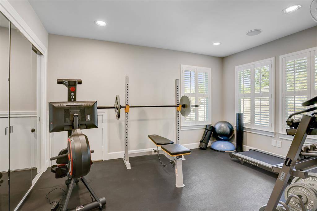 Adjacent to the game room, this bonus room is currently being used as a home gym.  The double sliding mirrored closet doors pull double duty - both to check your form during workouts but also to mask a wall-length closet for storage.  On the opposite wall are plenty of windows to let in the morning sun to help activate those endorphins!
