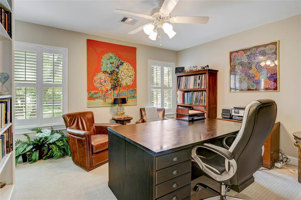 Currently utilized as an office, this secondary bedroom has textured low pile carpet, bright windows with plantation shutters, built-in bookcase, and walk-in closet.  It shares a dual access style bathroom with an adjoining bedroom.