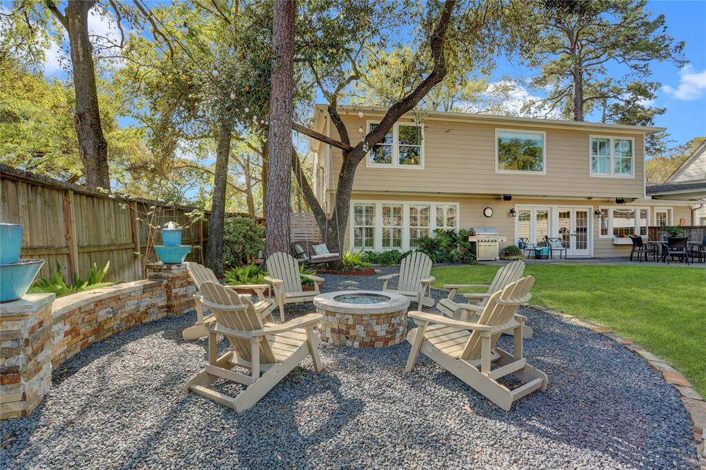 One of the homeowner's favorite spaces to unwind every night - built-in glass rock firepit with bench seating and a sweet tree swing for two.  The peaceful sounds and dancing lights will soothe your soul even after the longest days.