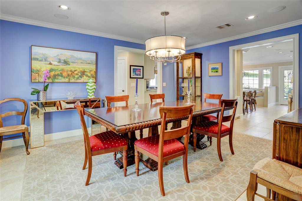 Formal dining is spacious and light with a modern chandelier and quick access to the living room, kitchen, and butler's pantry.