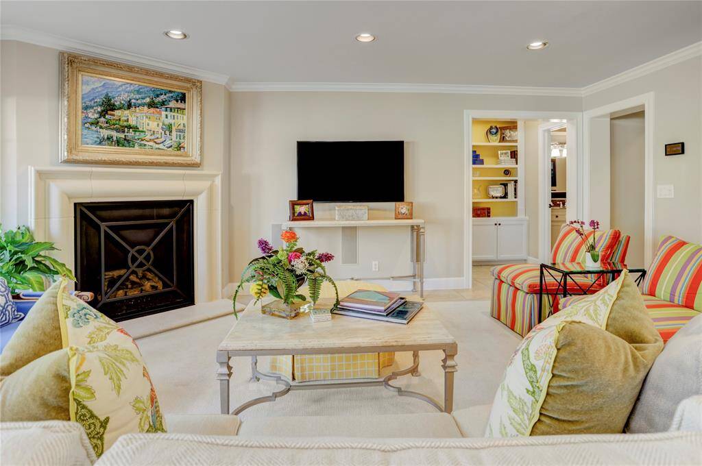 The oversized fireplace is a showstopper with its carved limestone surround and custom black steel screen. This room is also wired for surround sound and has a separate A/V closet to hide equipment.