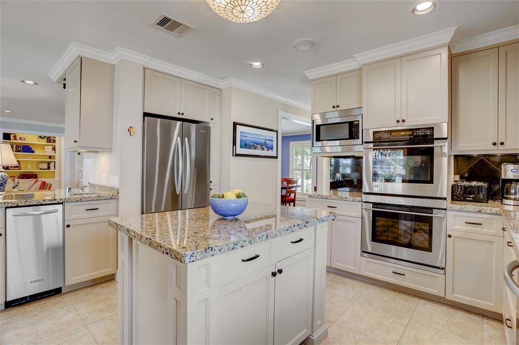 Stainless steel appliances include the five-burner gas stove, double convection oven, French door refrigerator, microwave and ice maker.