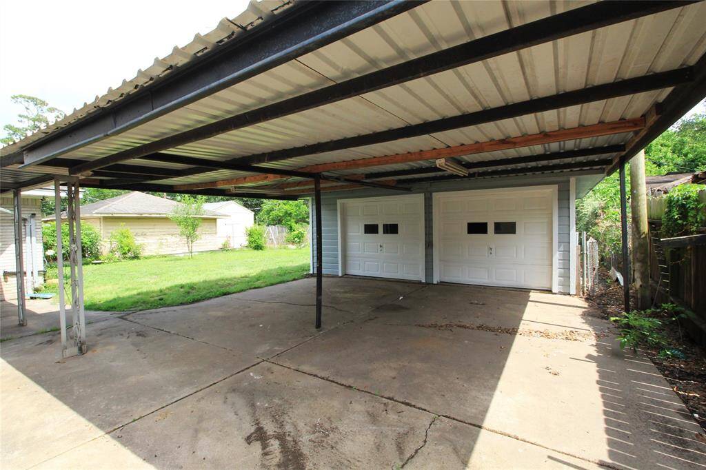 Oversized double carport in front of 2-car garage
