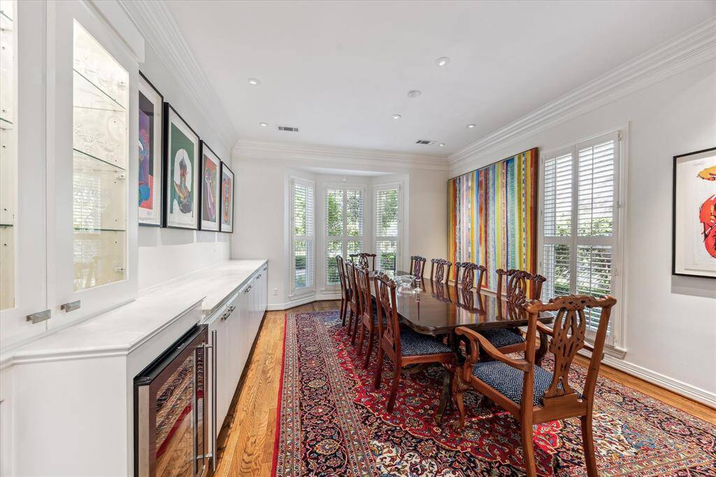 Formal dining room with beverage refrigerator and generous built ins.