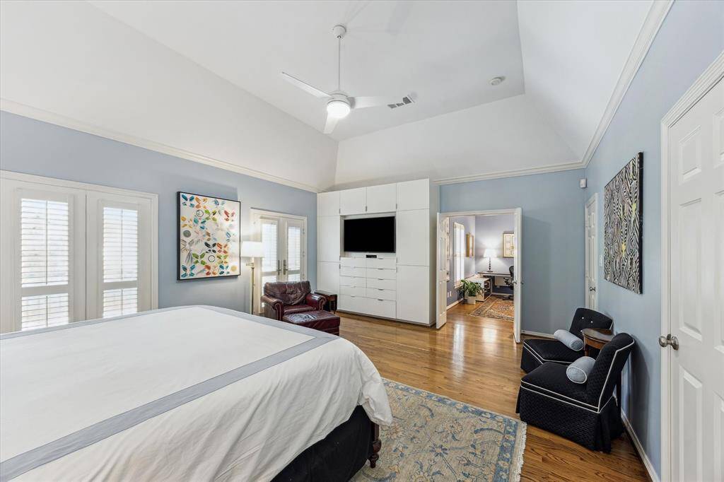 Another view of the primary bedroom with built ins and direct access to home office.