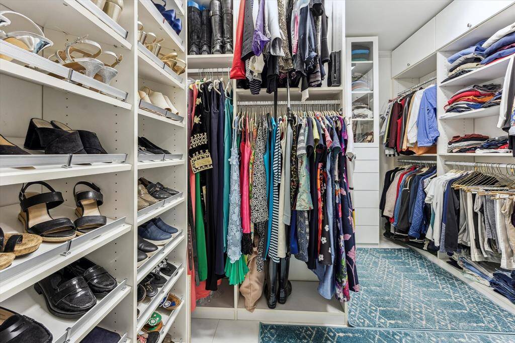 Primary closet with his/her sides.