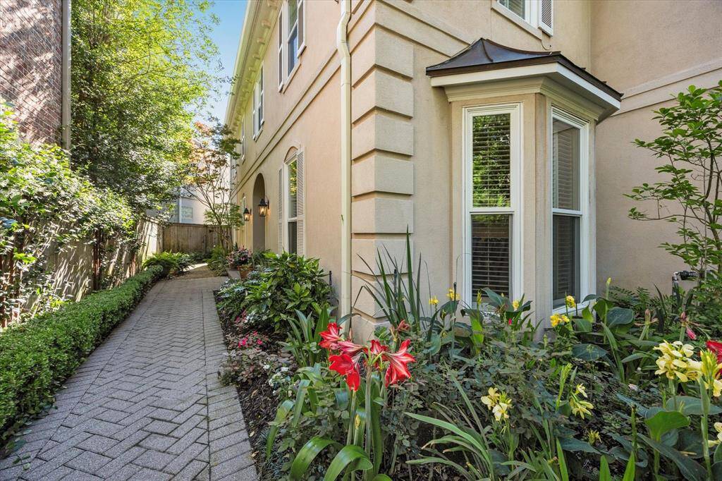 Gorgeous landscaping lines the walk to the front door.