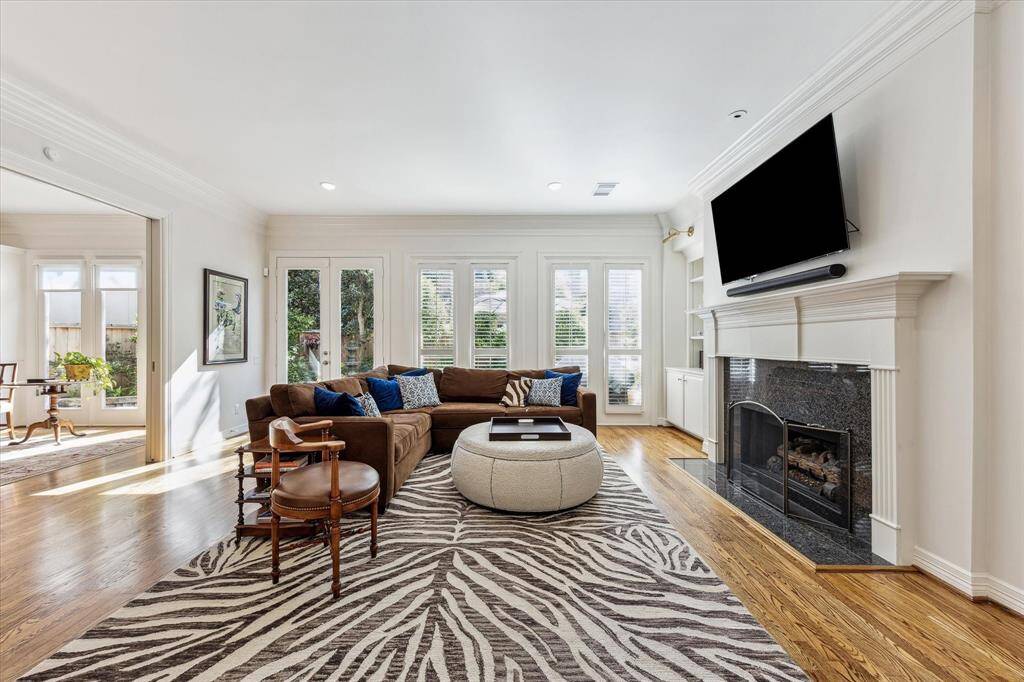 Family room features cozy gaslog fireplace, ample built ins, and access to the patio.