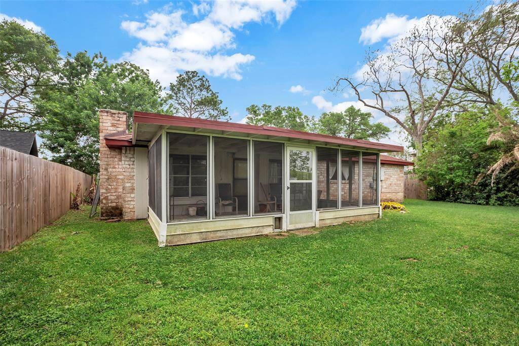 Enjoy the outdoors year-round in the enclosed patio at the back of the house, offering a versatile space for relaxation and entertainment.