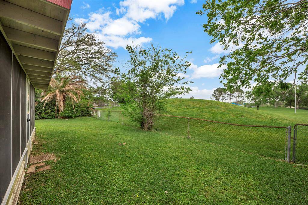 Enjoy the serene ambiance of the backyard from the comfort of the covered patio.