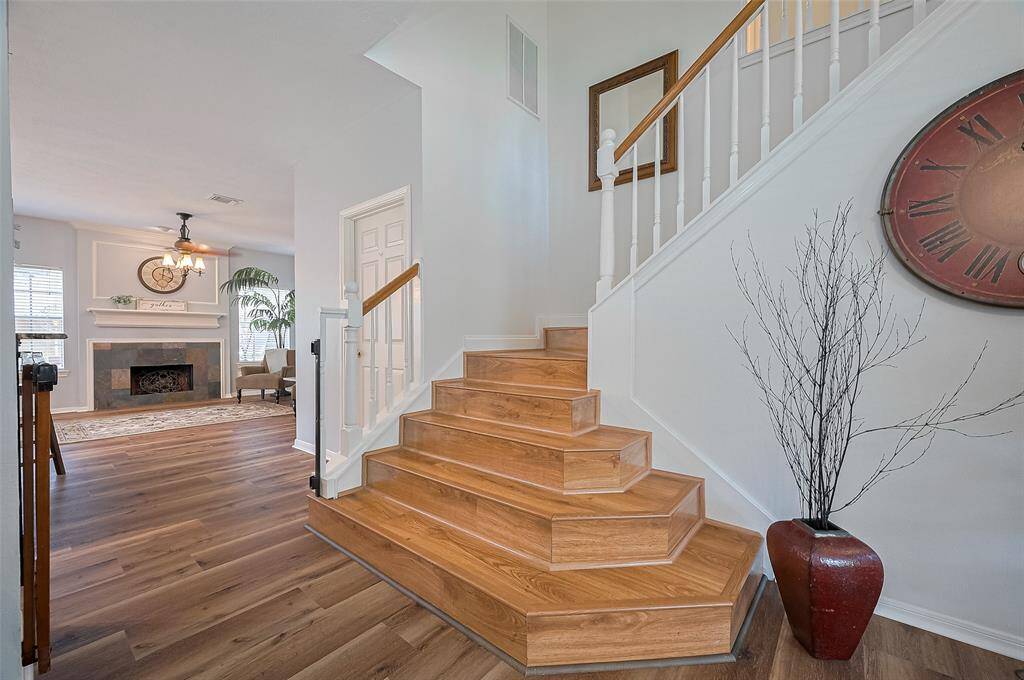 Just past the stairs, the door opens to walk in laundry room with storage shelves