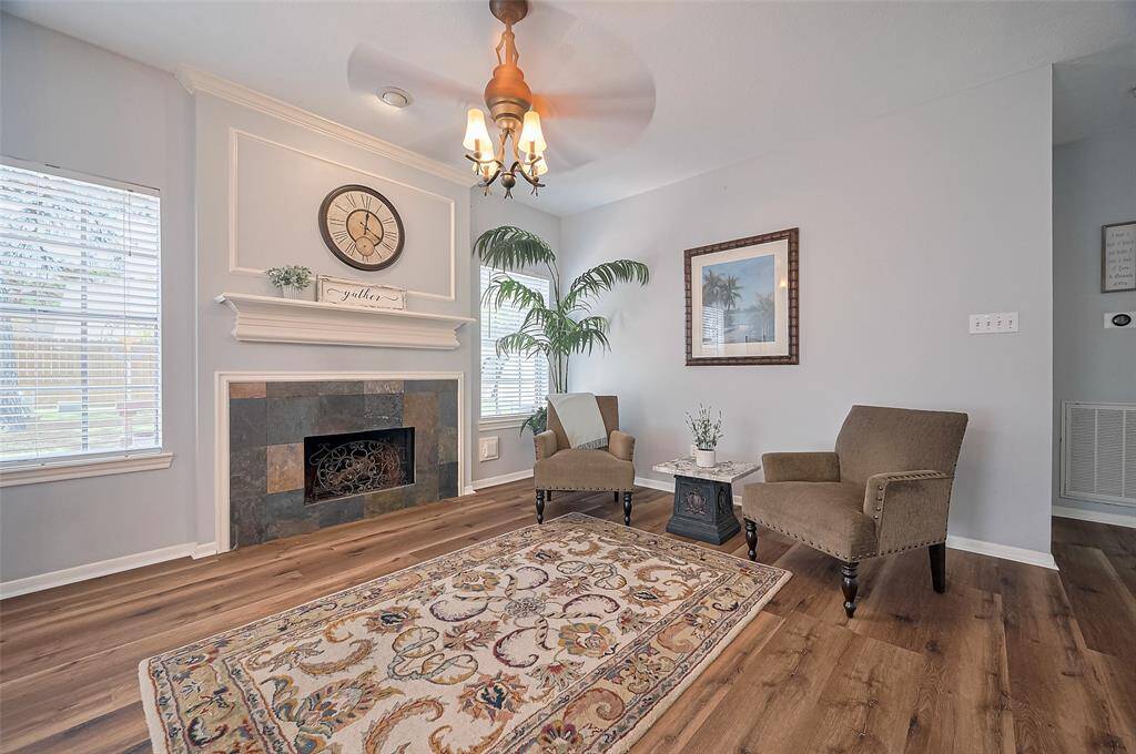 Cozy living room with a charming gaslog fireplace, seamlessly connected to the kitchen.