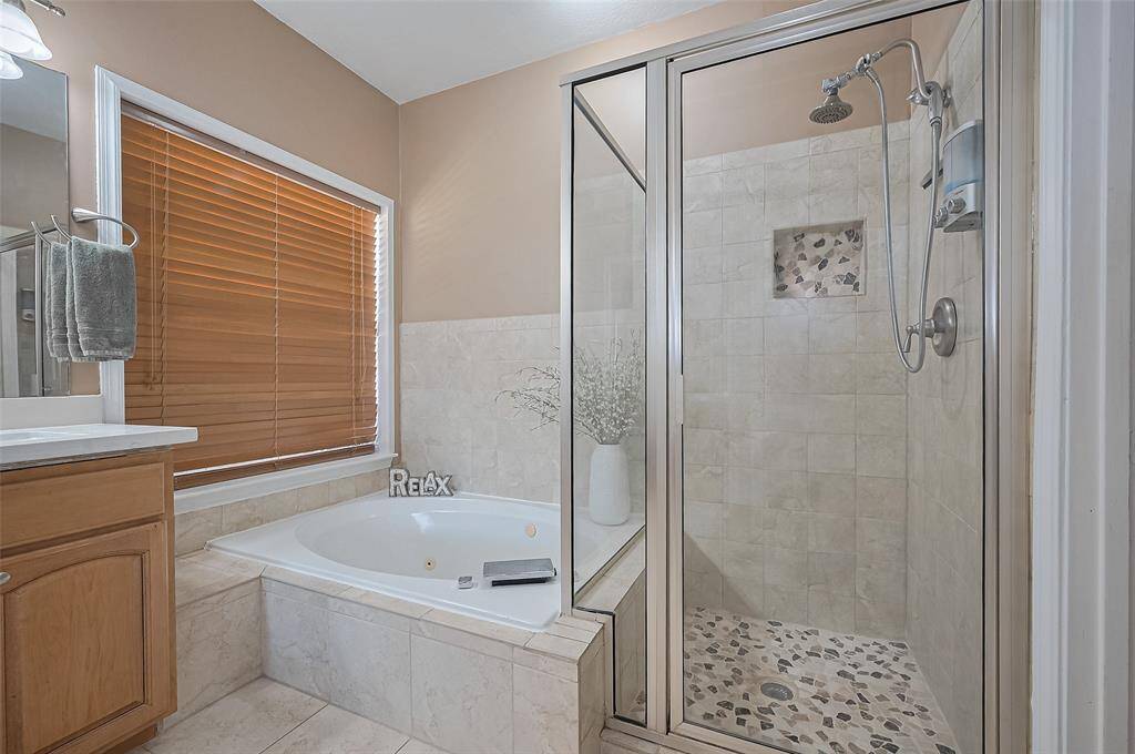 Relaxing tub and stylish glass shower, perfect for unwinding.