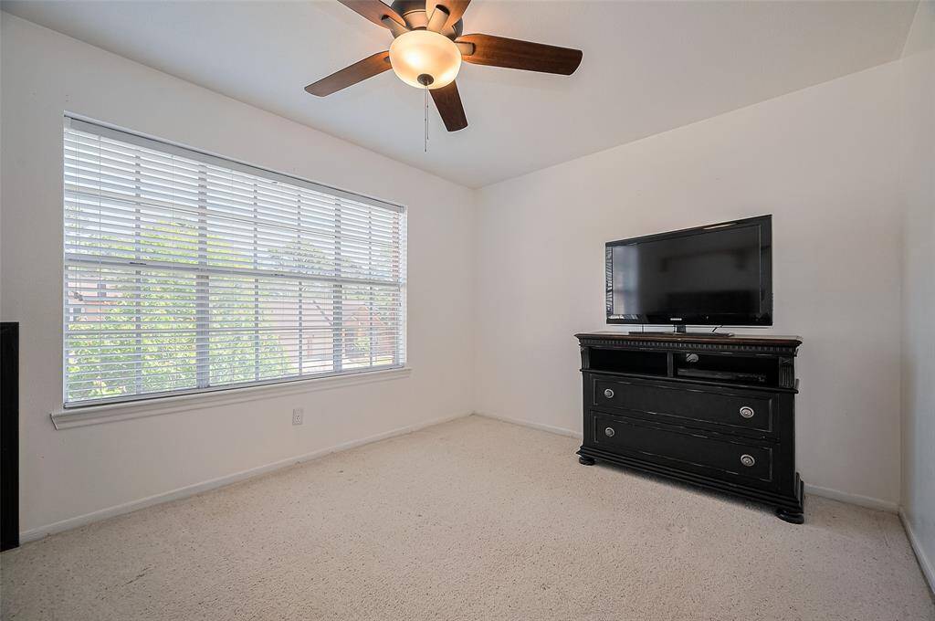 Spacious secondary bathroom with ample counter space.