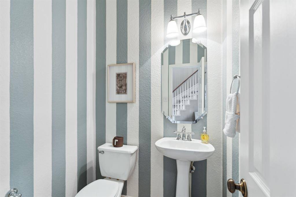 The powder room is tucked away for privacy, yet easily accessible from the foyer.
