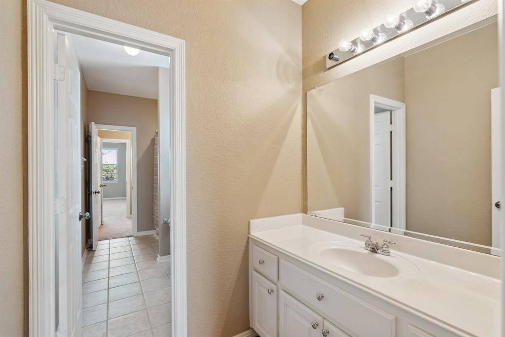 A  Jack-and-Jill bathroom shared by two secondary bedrooms.