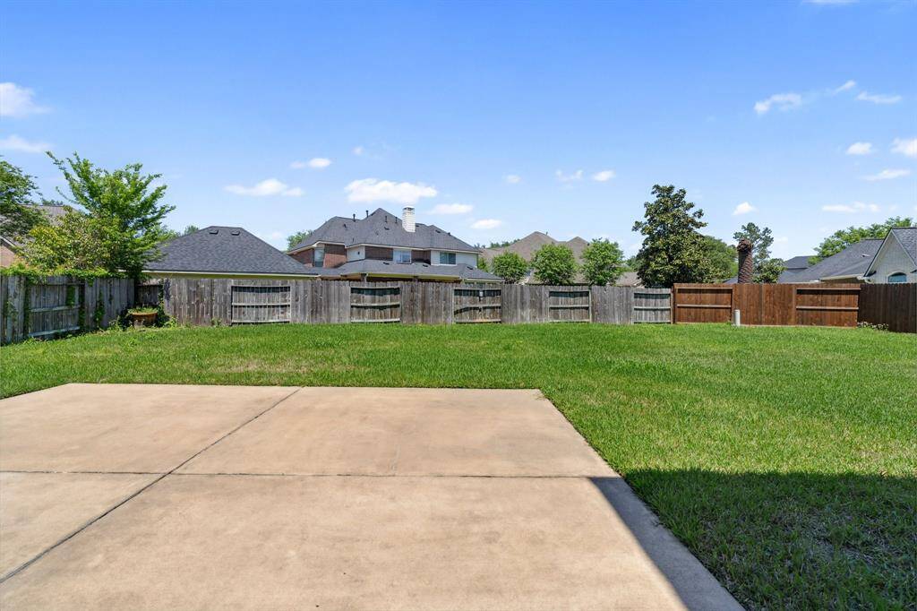 Step outside to the large backyard with a covered patio, perfect for outdoor dining or relaxing.