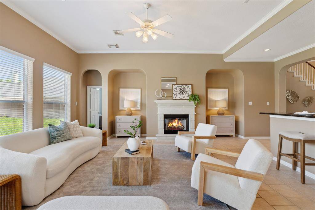 The inviting living area features a cozy gas fireplace and two media niches—ideal for relaxing or entertaining.