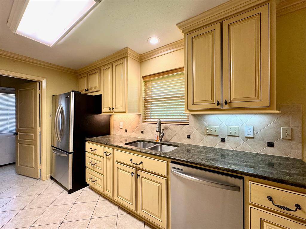 All stainless steel appliances in the kitchen, including gas stove, wall-mounted oven/microwave, dishwasher, and French door refrigerator.