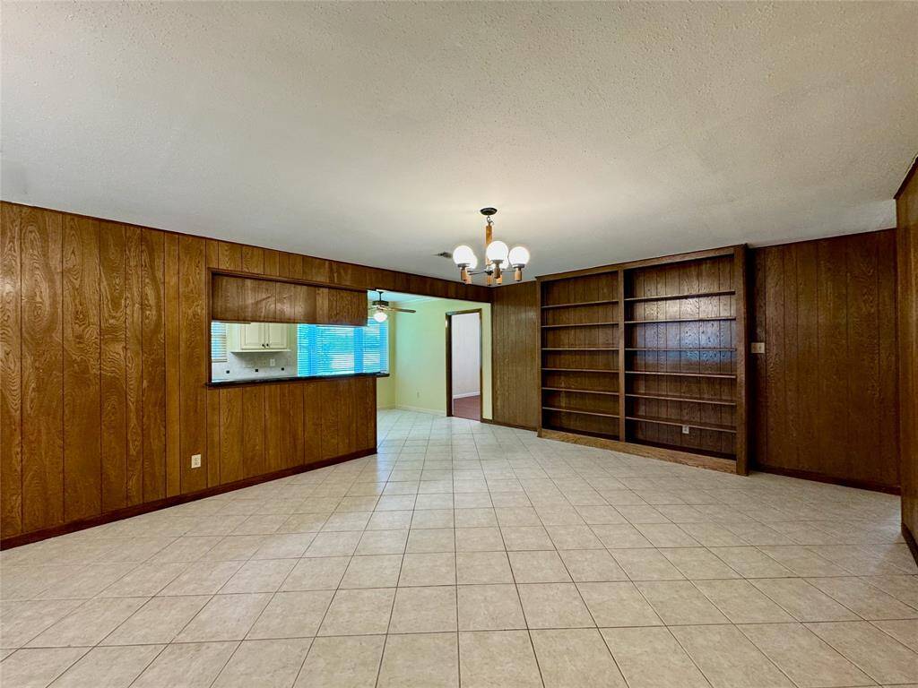 Built-in bookshelves line the living room wall.