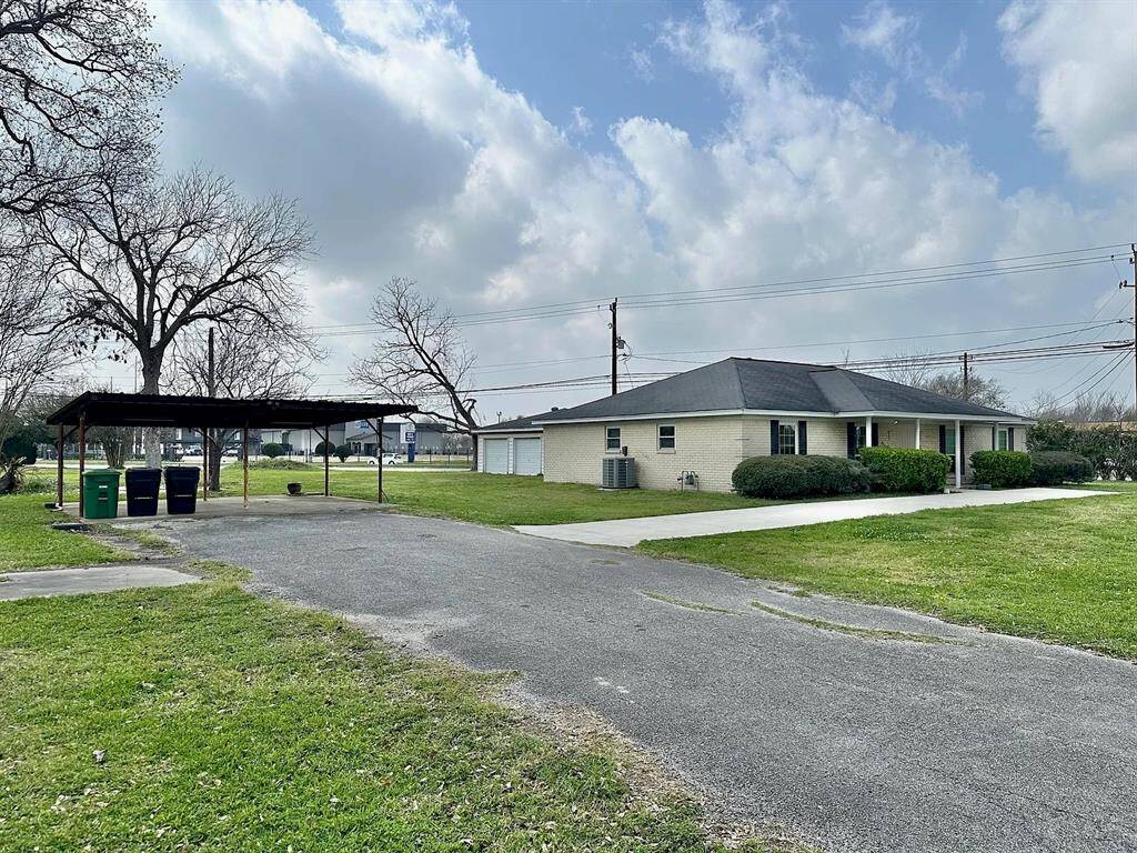 Expansive driveway with additional pull-out by the front door. Two-car carport.