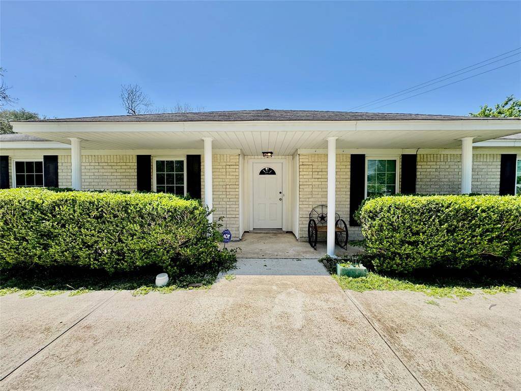 Long, covered front porch leads you in.