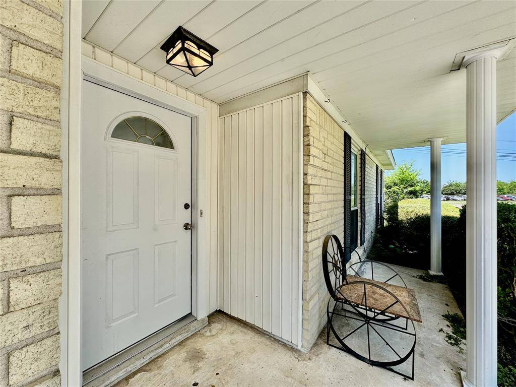 Long, covered front porch leads you in.