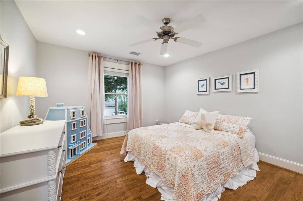 Secondary bedroom located on the 2nd floor with hardwood floors, recessed lighting, walk-in closet, ceiling fan and window coverings.