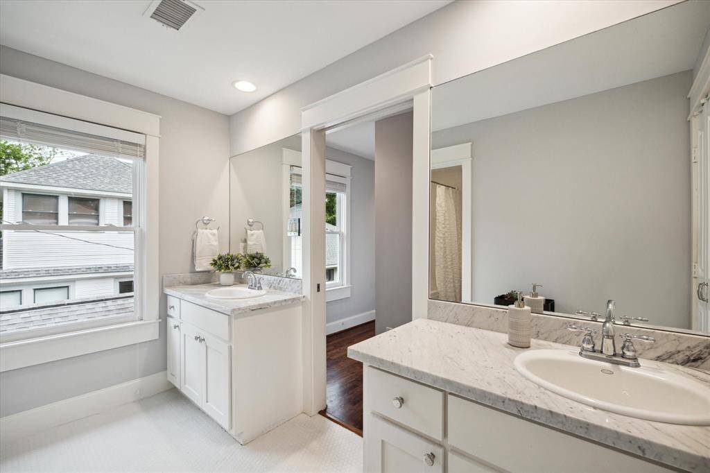 The second-floor hall bath has marble counters, double sinks, and a shower/tub combo. A perfect configuration for the secondary bedrooms.