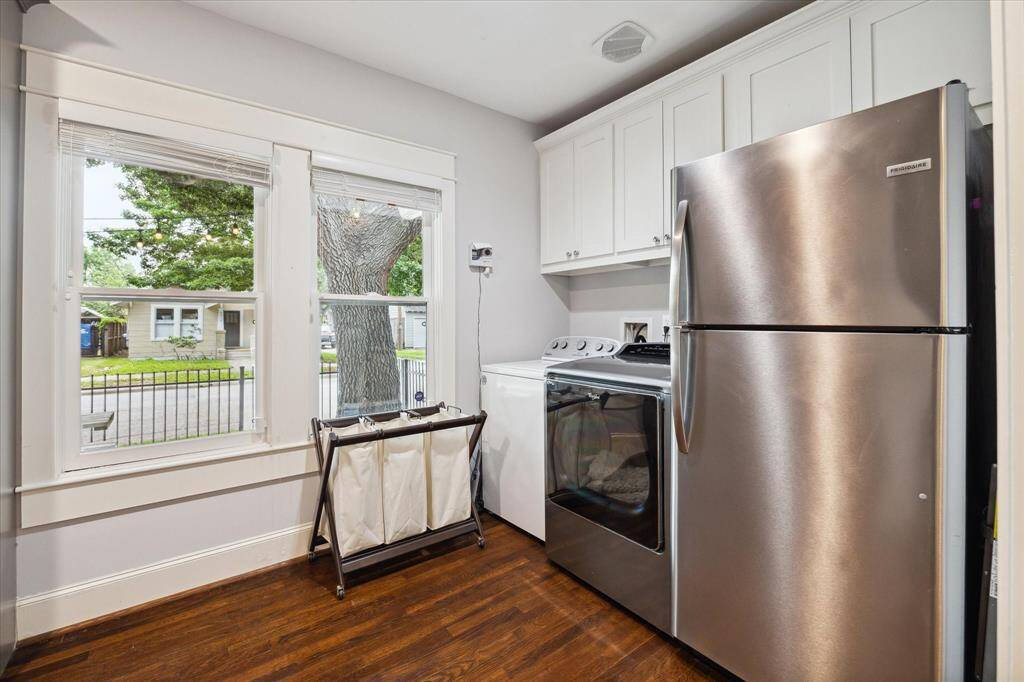 Laundry room with built-in storage and room for a secondary refrigerator.