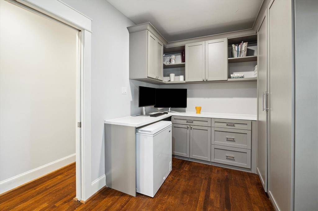 Home office nook with custom built-in cabinetry, soft close cabinets, pull out shelf for a printer, file drawers and cord management. This office nook provides two possible work from home spaces!