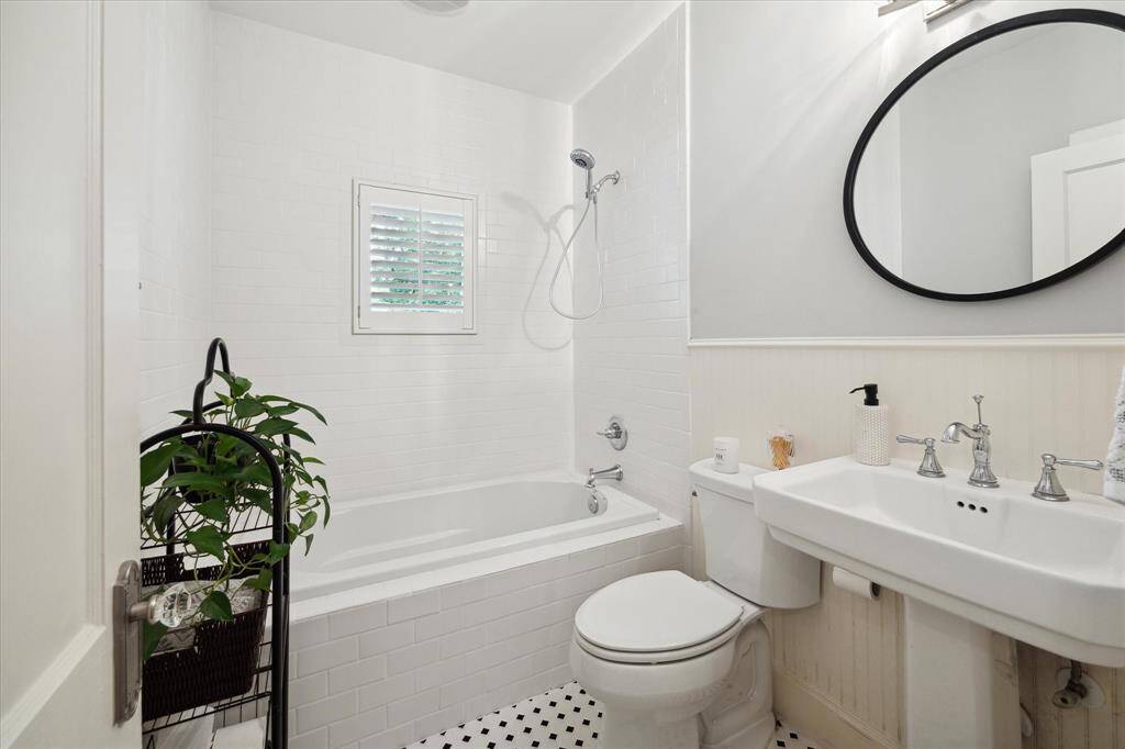 Full bath on the first floor with a timeless pedestal sink and tub/shower combo.