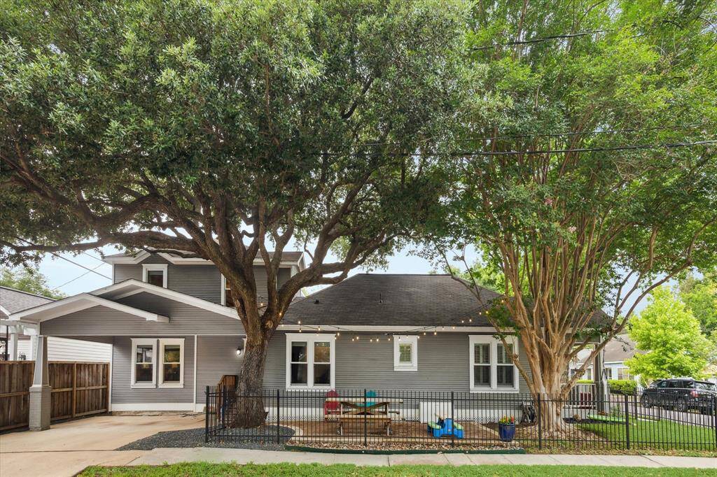 Beautiful view of the side of the house and the two-car carport with the doublewide driveway.